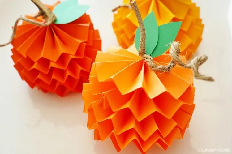 Colorful pumpkins made from folded construction paper