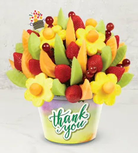 An edible arrangement of fruit in a tin reading Thank You- teacher gifts