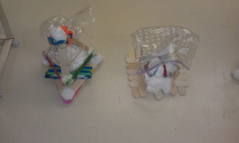 ships made from popsicle sticks for an egg drop challenge
