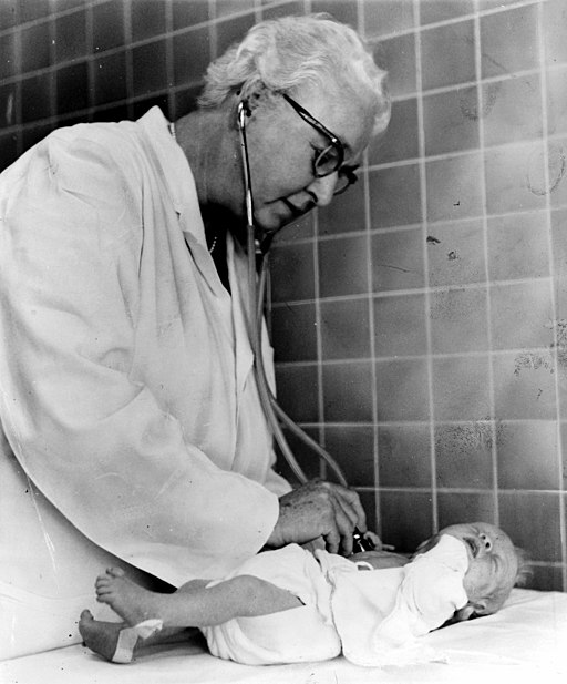 Black and white photo of Dr. Virginia Apgar performing an Apgar test