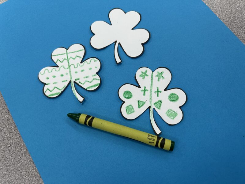 shamrock paper cutouts with symmetrical shapes on their petals