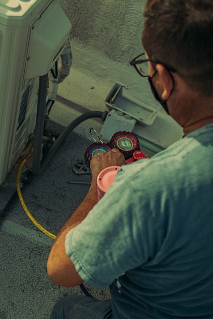 A HVAC repair technician works on an AC unit with specialized tools