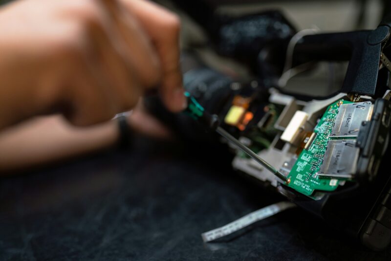 A maintenance worker repairs a circuit board
