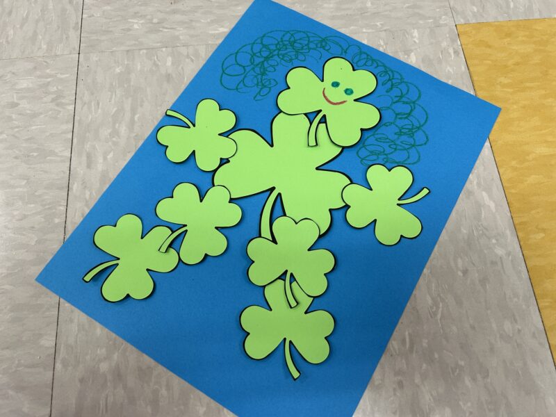 person made out of shamrock cutouts