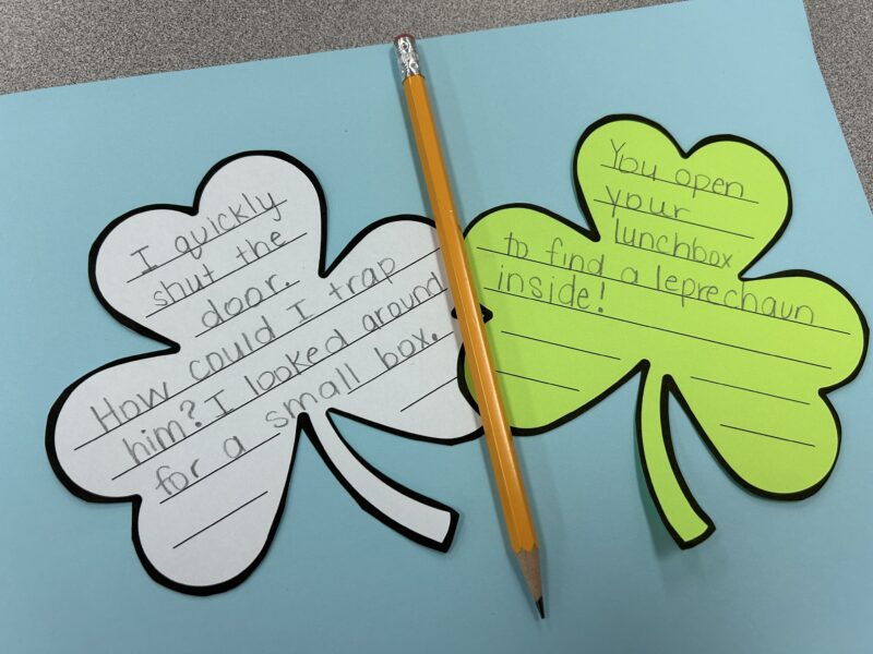 shamrock paper cutouts with story starters written on them- St. Patrick's Day activities