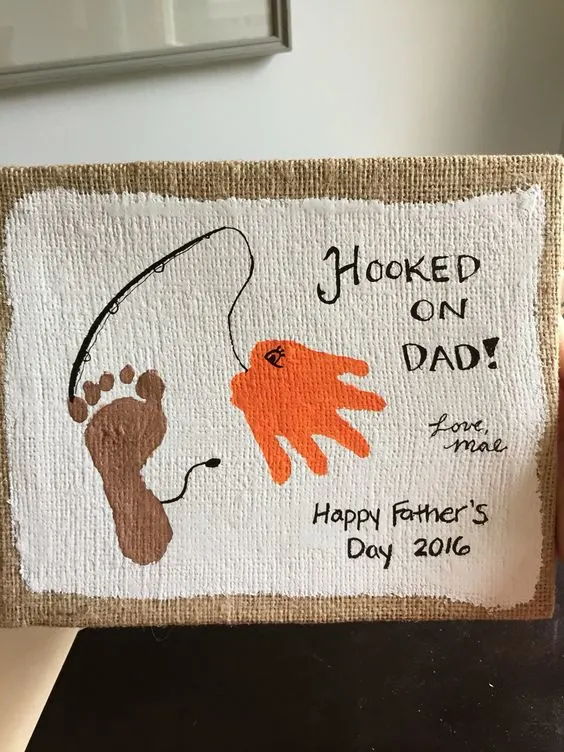 A canvas painted with a child's footprint and handprint