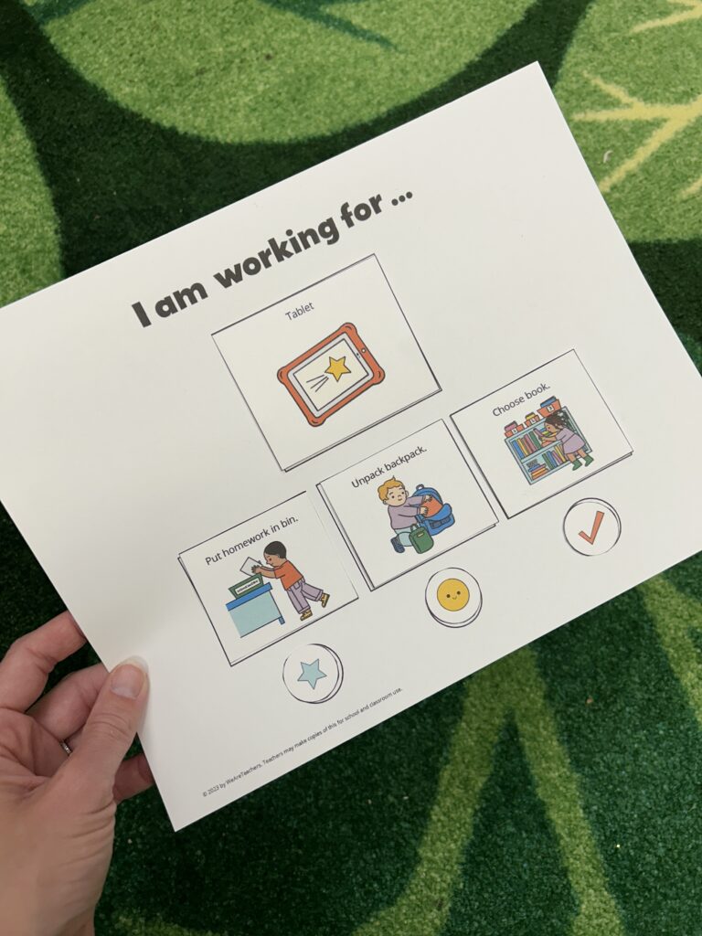 Hand holding work-reward board with I am working for.. written on it 