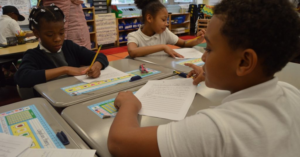 students at desks in group pods arrangement