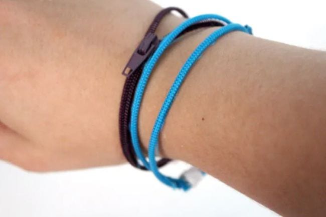 DIY fidget toys: Student wearing blue and black bracelets made of zippers