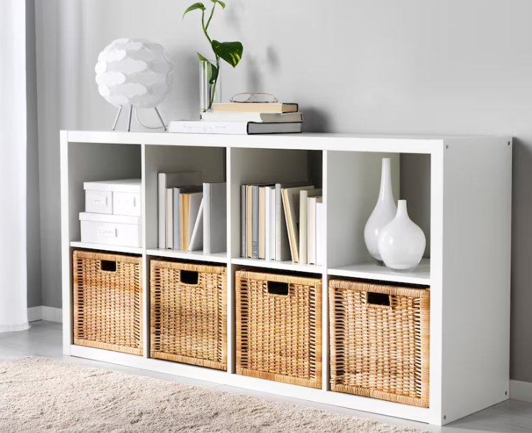 Basket A white cubby bookshelf is shown with brown wicker baskets in the bottom shelves.