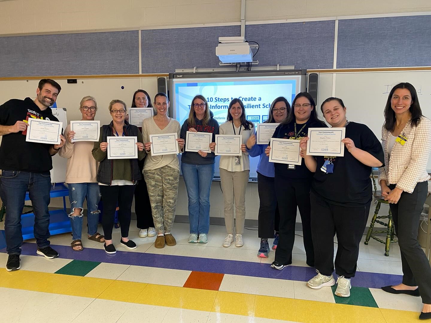 Image of New Jersey teacher of the year with a group of teachers she trained