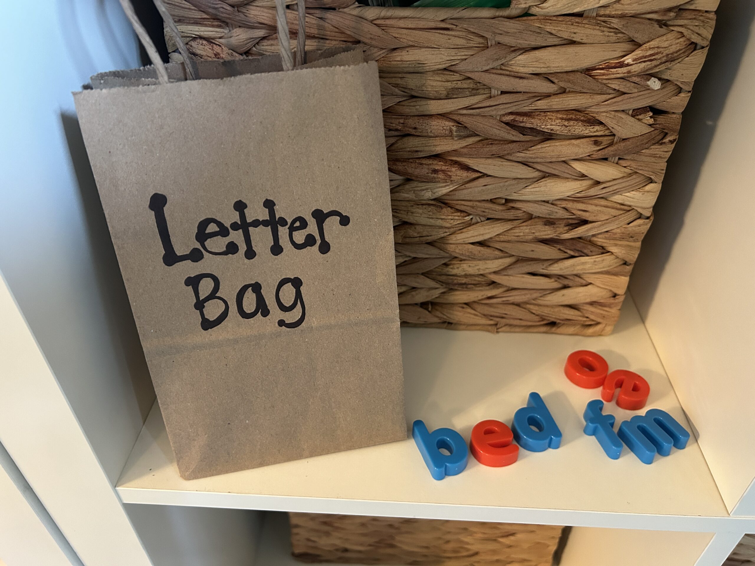 Brown paper bag filled with plastic letters as an example of phonics activities.