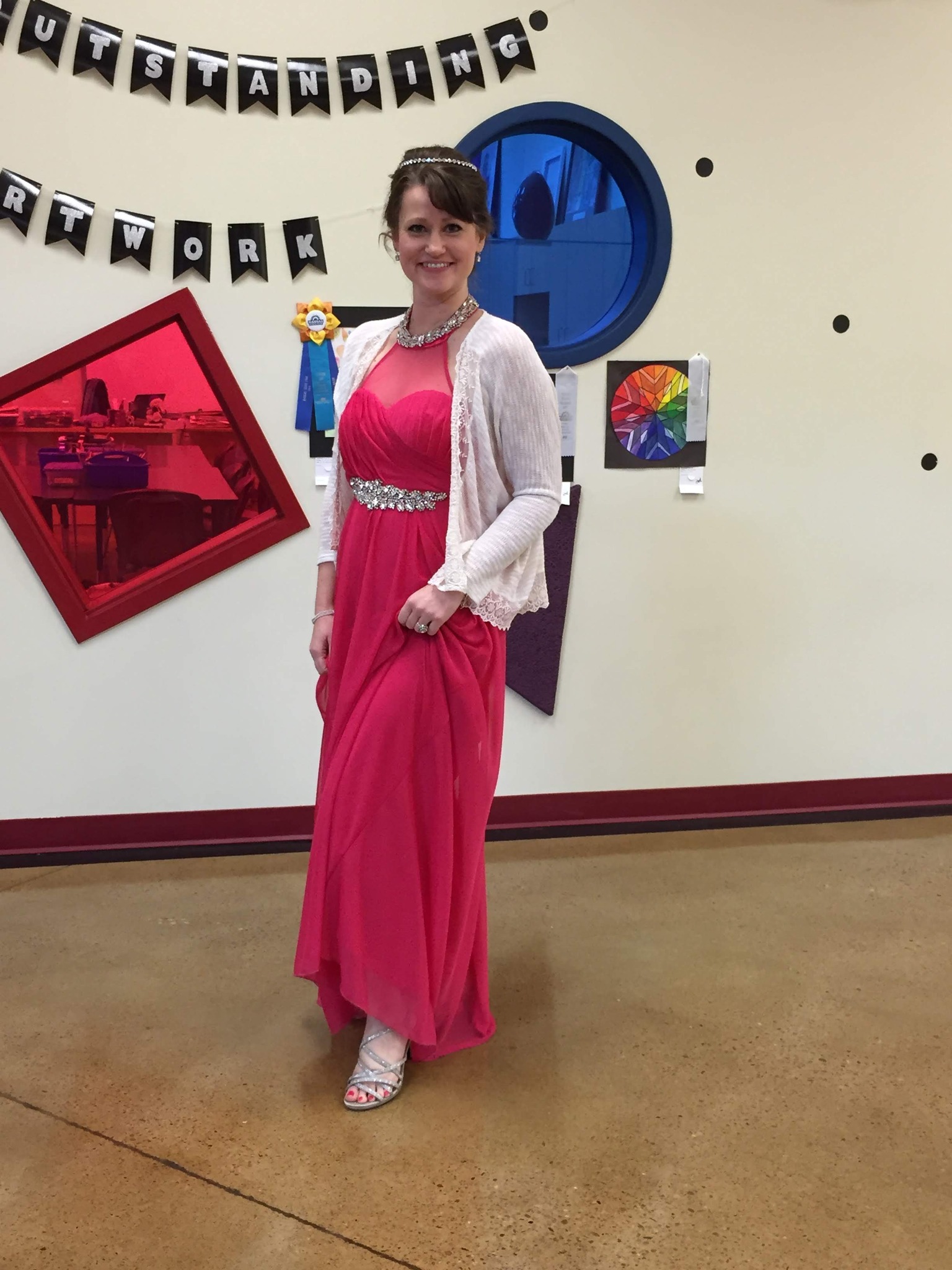 Teacher dressed as a queen in a formal gown and crown