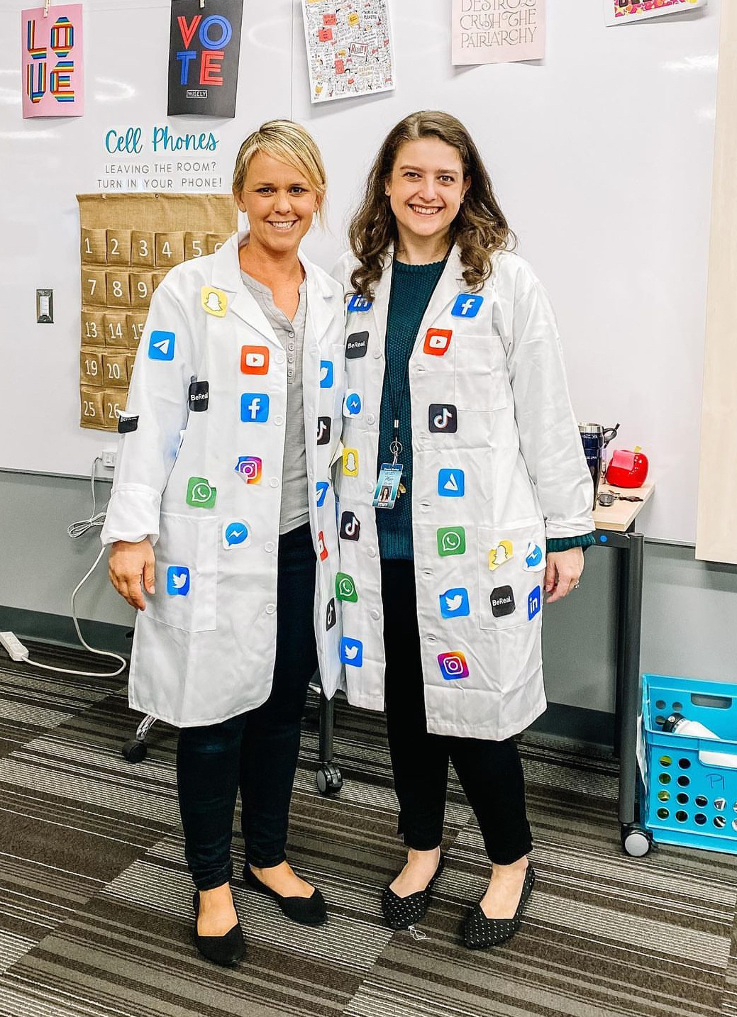 Teachers wearing lab coats covered in social media logos, as social scientists