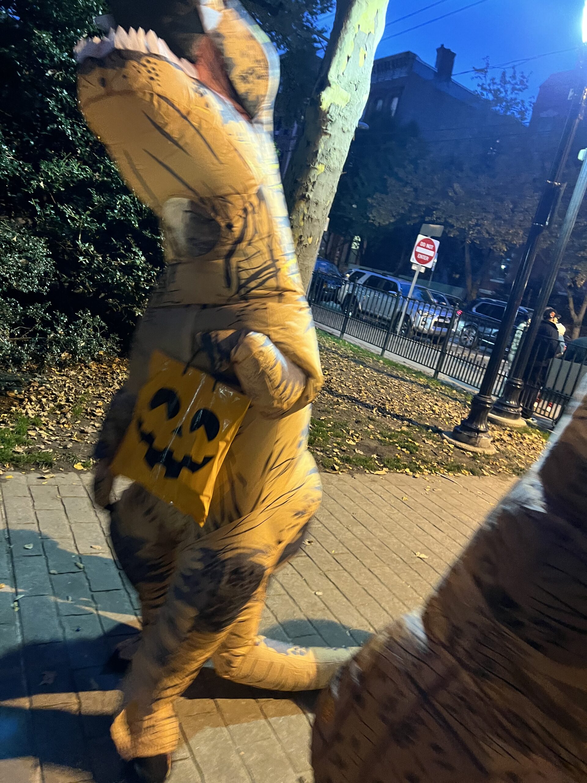 Teacher wearing an inflatable t-rex costume for Halloween