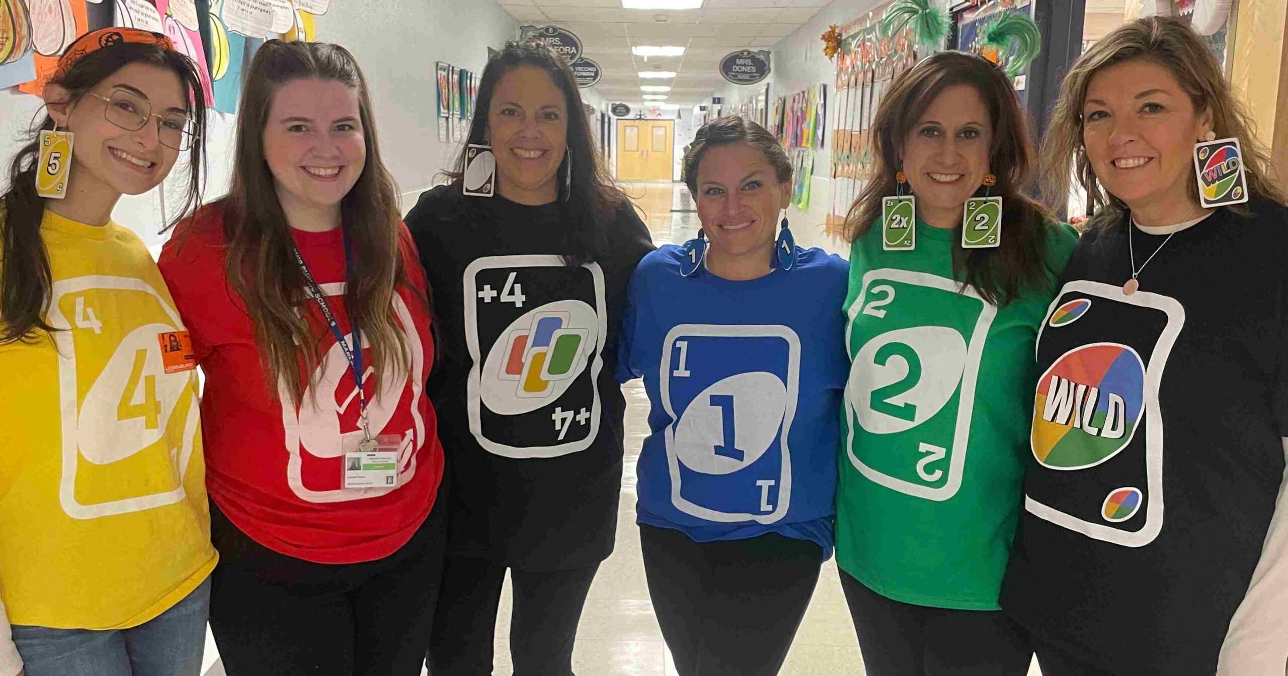 Group of teachers dressed in UNO card shirts and matching earrings