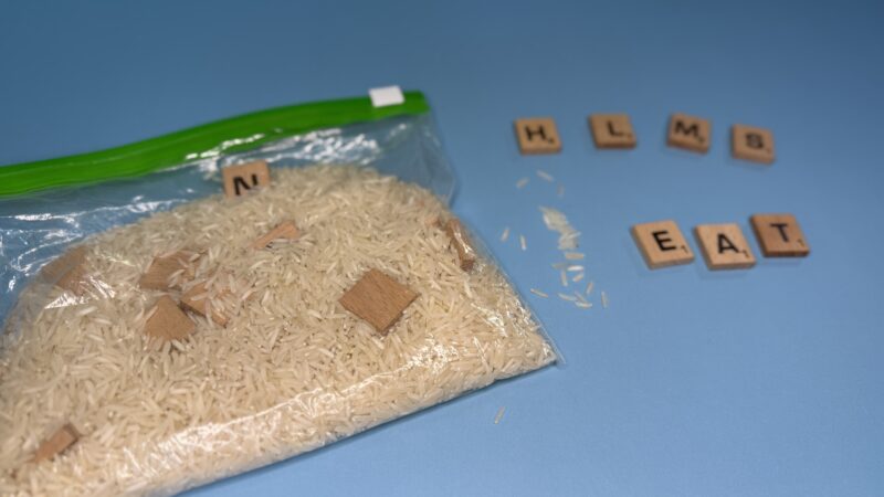 Bag of rice with beads of letters of alphabet in them