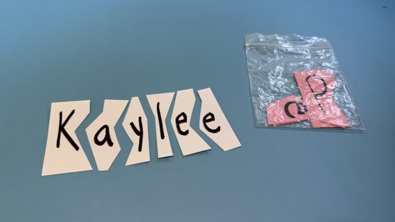 Name Kaylee written on paper and cut into strips by letter