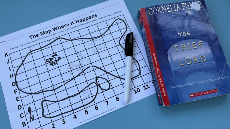 Paper with map drawn on it next to book