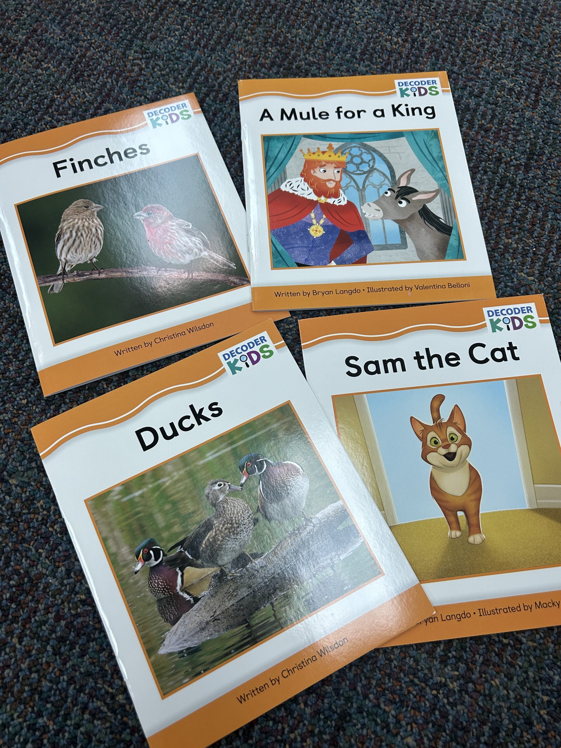 Why I’m Hooked on Decoder Kids Phonics for Early Literacy Success Pictures of four books from Decoder Kids Phonics Kits