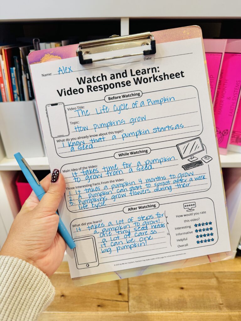 Free Video Response Sheet as a Growth Mindset Activity free video response sheet printable on a clipboard being help up by a person who also has a blue pen
