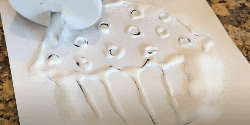 SaltPainting_Step4 A cupcake coloring page that has glue drawn along the lines has salt painted over it.