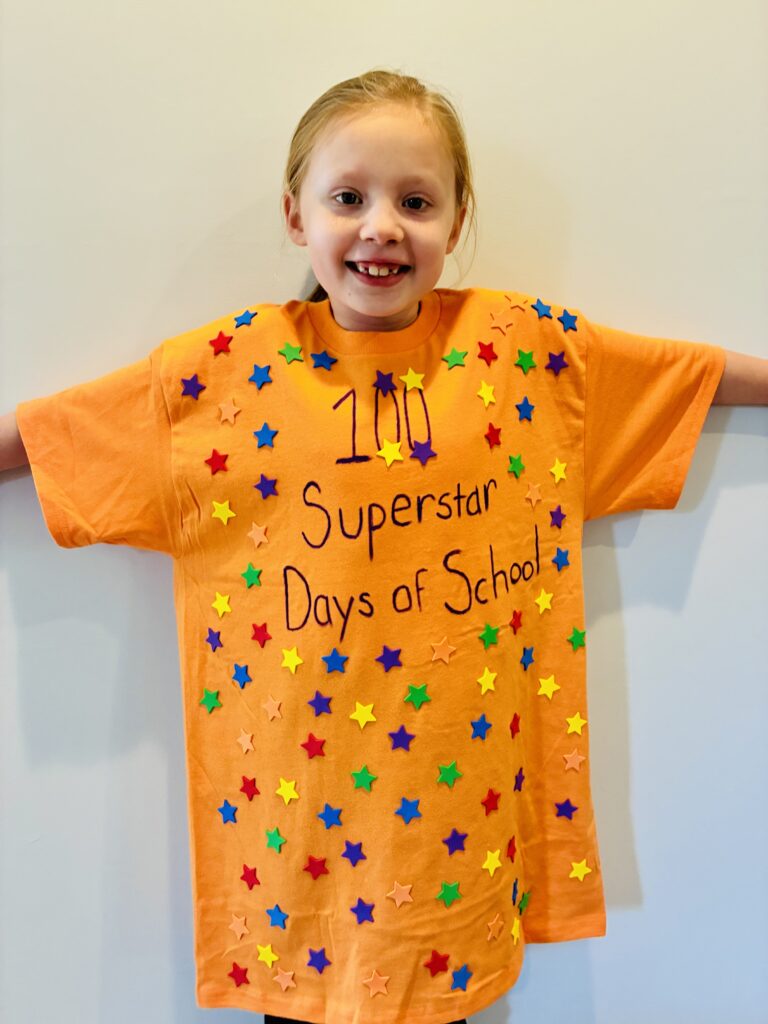 a student wearing a orange shirt with the words 