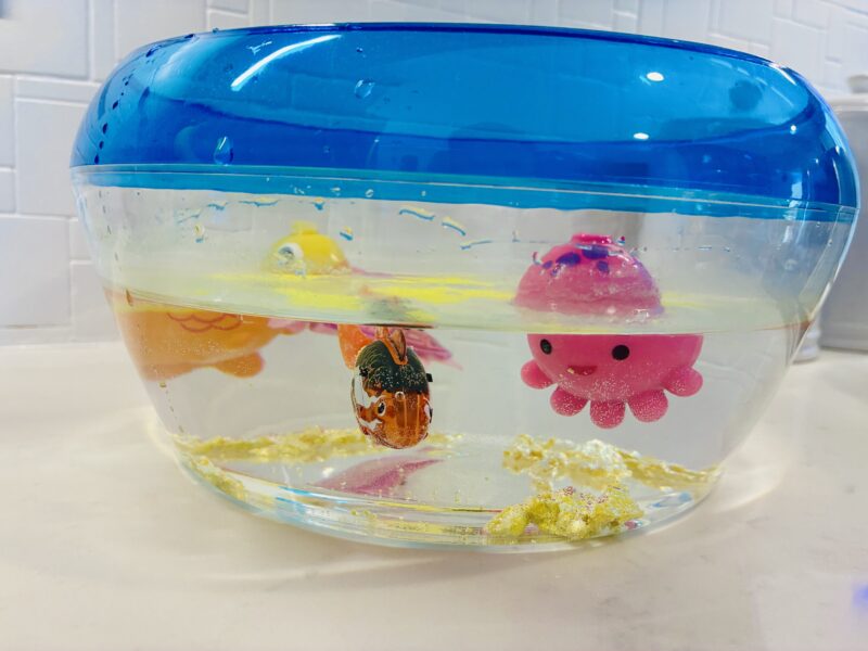 a sensory bin full of water and ocean animals