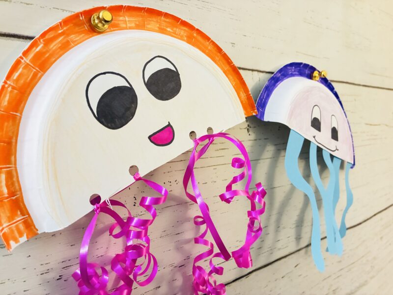 paper plate jellyfish ocean craft hanging on a bulletin board